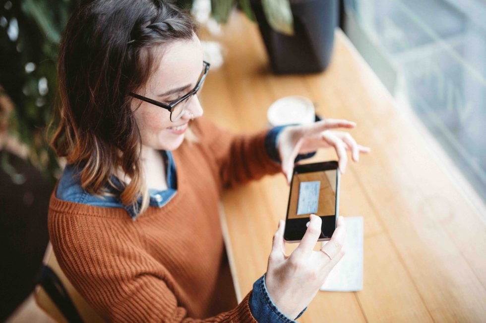 person depositing check with mobile phone